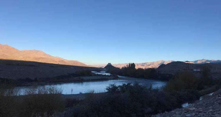 River view at dusk with mountains in the distance.