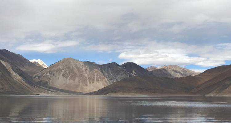 Clear lake with surrounding mountains visible.