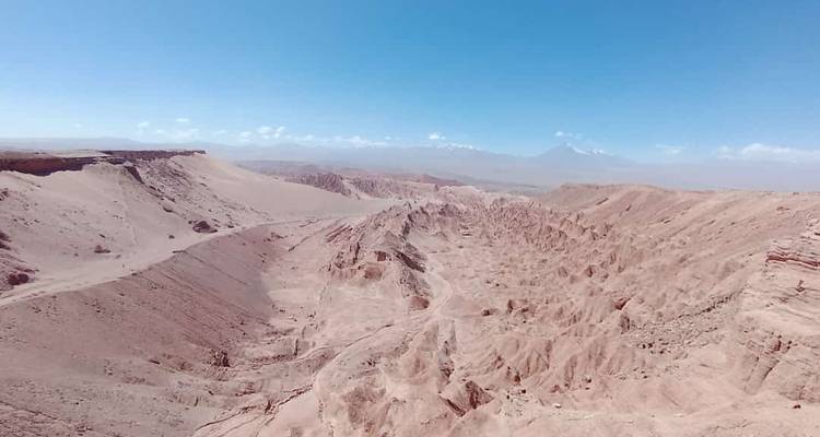 Vast landscape of rugged terrain with distant mountains, possibly in Atacama Desert.
