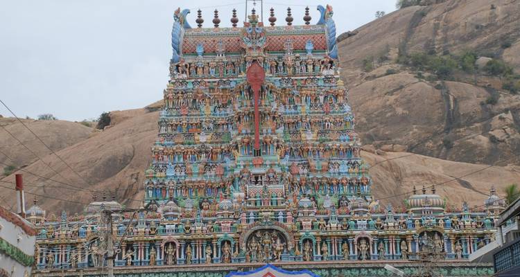 Decorated temple with a rocky background.