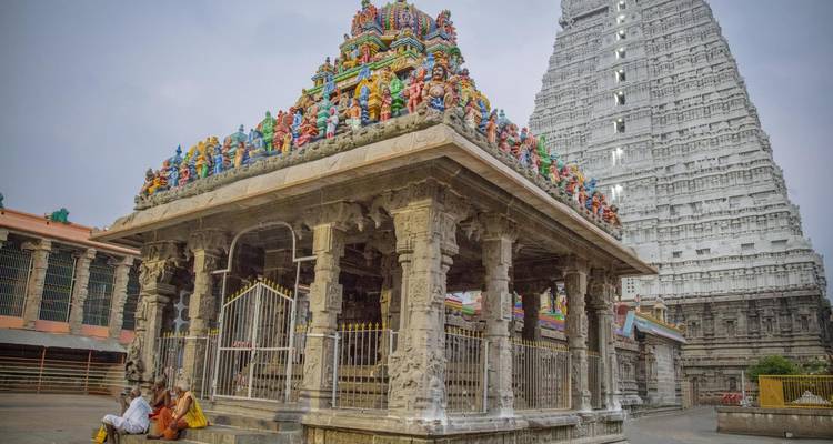 Intricately carved temple structure with visitors.