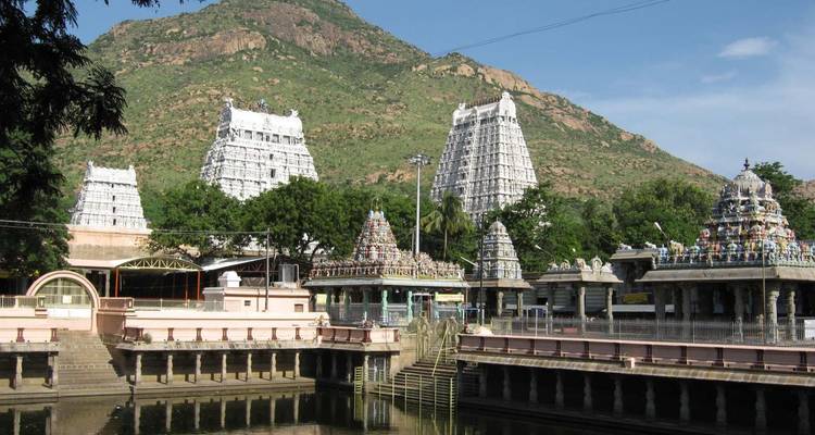 Complex of Hindu temples with mountainous backdrop.