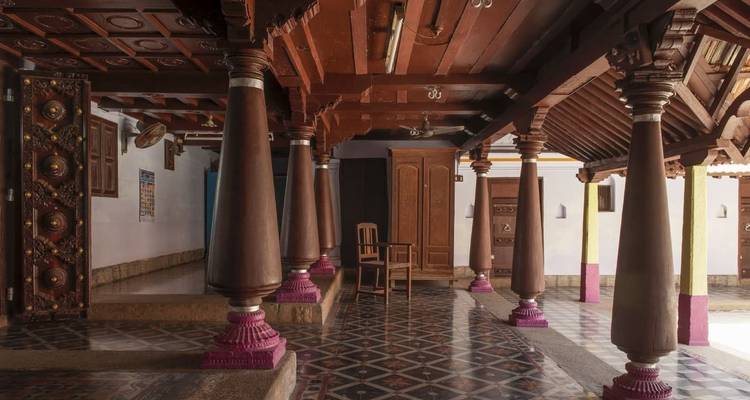 Interior view of a building with ornate wooden columns.