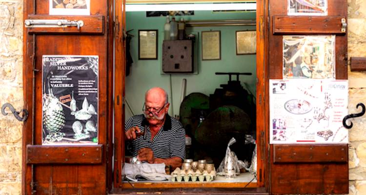 Man doing metalwork in a small shop.