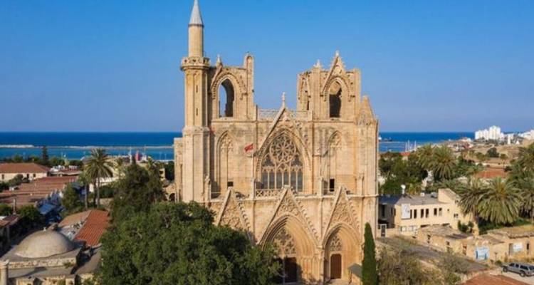 Gothic cathedral-turned-mosque rising above Famagusta with the sea in the distance.