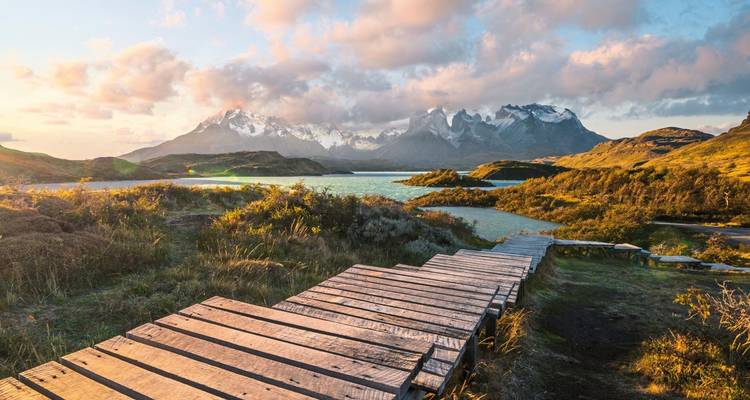 Scenic view of a lake with mountains in the background at sunrise.