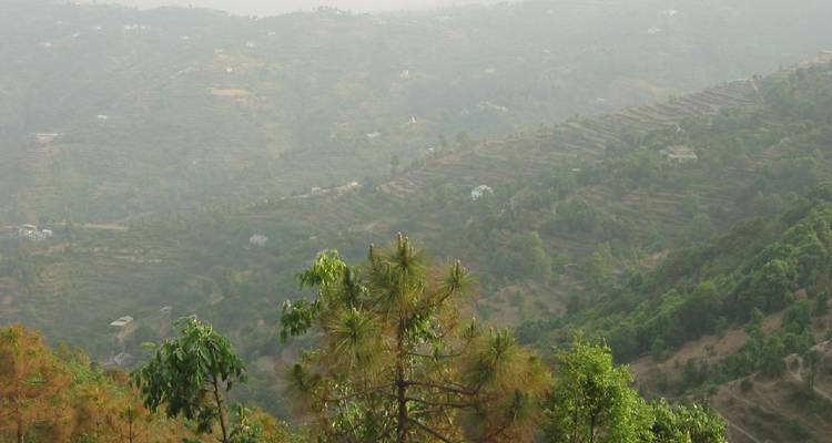 Hazy mountain landscape with terraced fields.