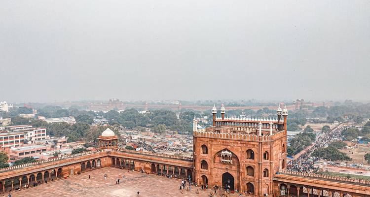 Historic gate with view over the city and distant skyline.