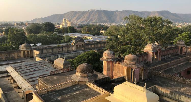 Aerial view of Jaipur cityscape with hills in the background.