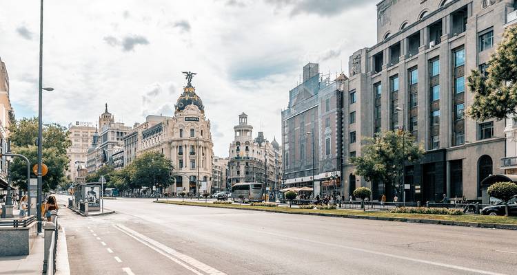 Gran Vía street in Madrid with historic buildings and people.
