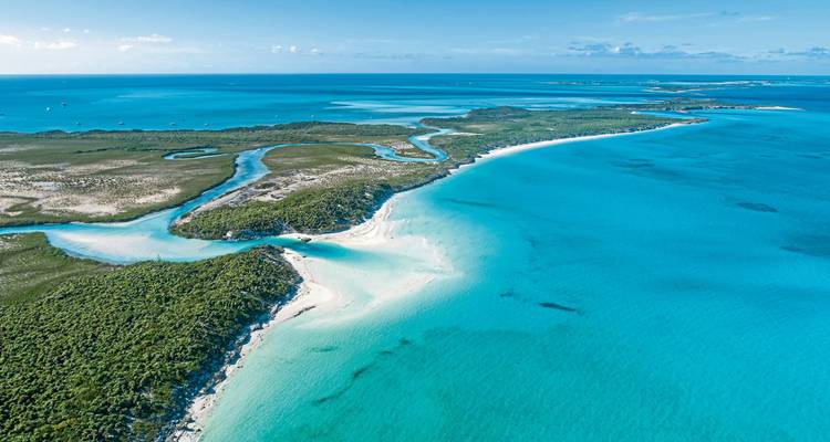 Aerial view of coastline and turquoise waters.