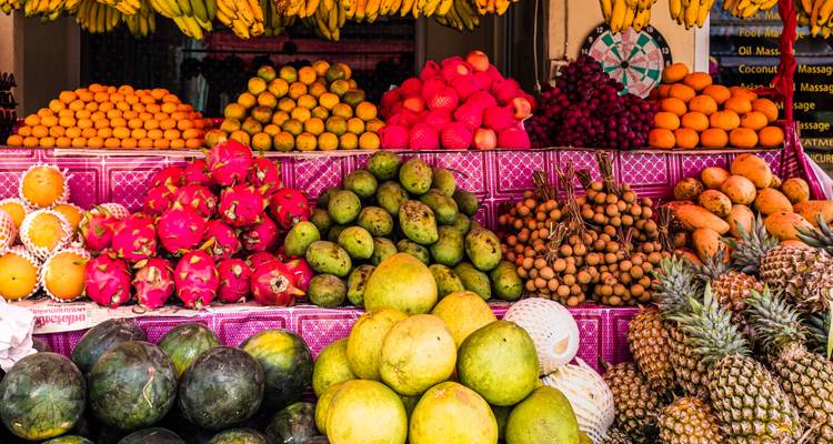 A vibrant fruit market display with various tropical fruits.