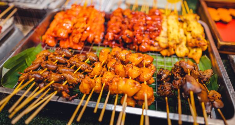 Street food with a variety of grilled skewers.