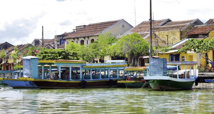 Colorful boats moored along a riverfront town.
