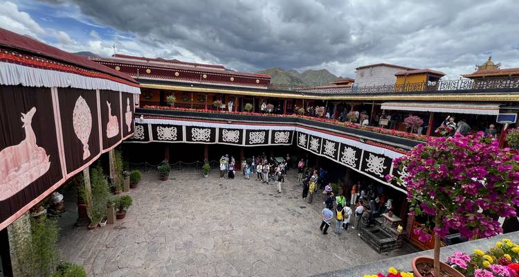 Courtyard with people and traditional decorations.