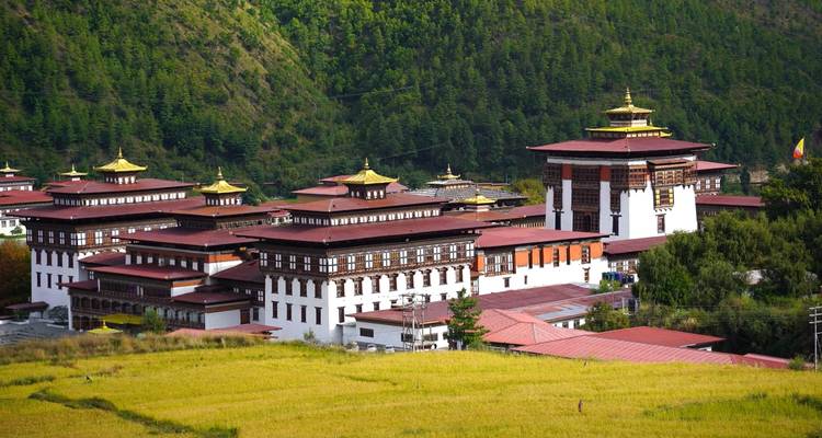 Dzong surrounded by forested hills.