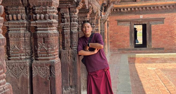 Mann, der sich gegen einen traditionellen Holzpfeiler lehnt.