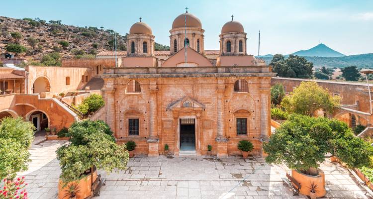 Historic monastery with a mountainous backdrop.