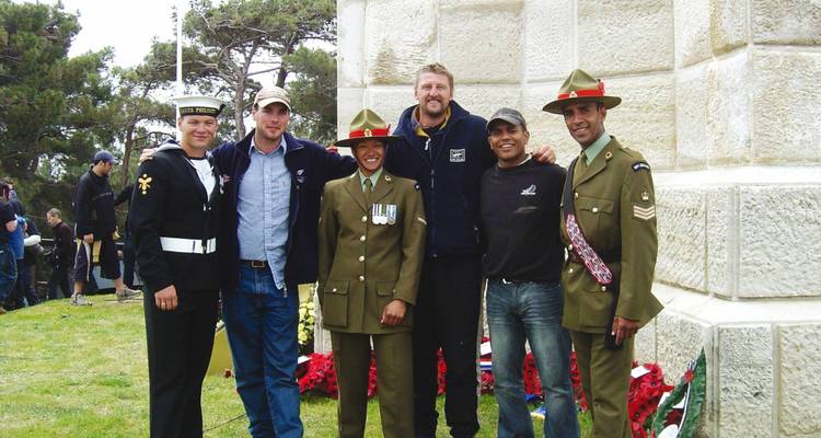 Group photo of people in military and casual attire.