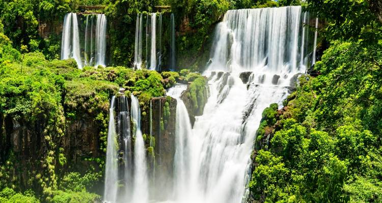Lush green surroundings of multi-tiered waterfalls.