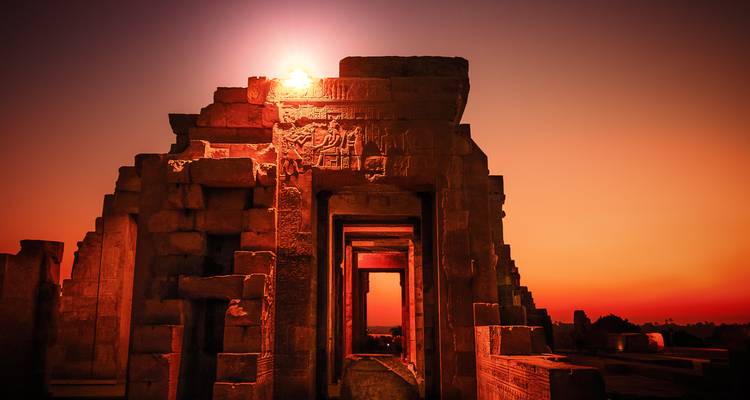 A sunset scene at Edfu Temple with sunlight shining through.