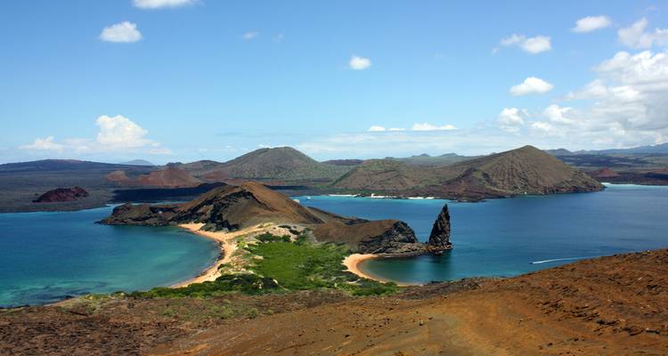 Sweeping panorama of Bartolomé Island showing volcanic cones, Pinnacle Rock and blue bays.