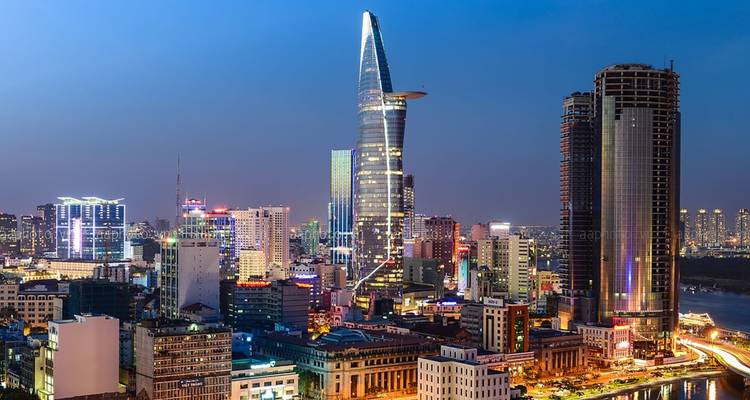Cityscape at night with a distinctive modern skyscraper.