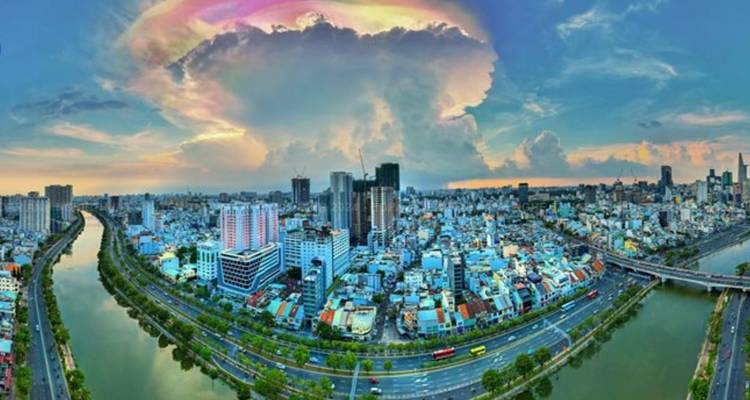 Wide-angle aerial view of a city with clouds.