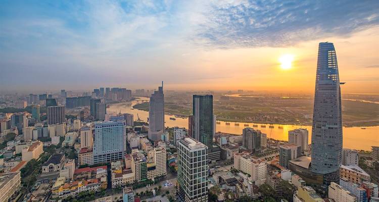 Sunset view over a city with tall modern buildings.
