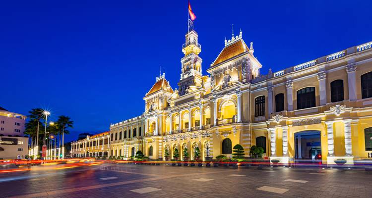 Illuminated colonial-style building at night.