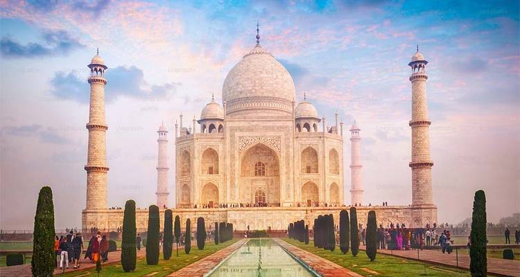 The iconic Taj Mahal with people in front, under a colorful sky.