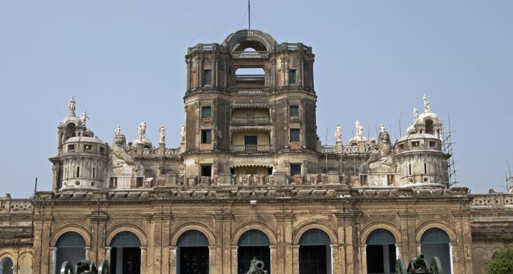 A large colonial-era building with a central dome and statues.