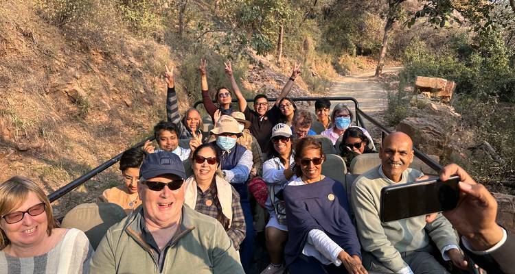 Excited group of tourists in a safari jeep.
