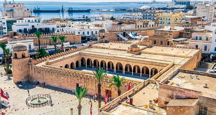 Aerial view of Medina of Sousse with fortifications and sea in the background.