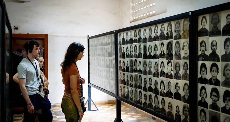 People viewing historical photographs in a museum.