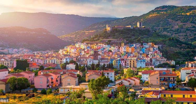 Colorful hillside town with a castle on the hill.
