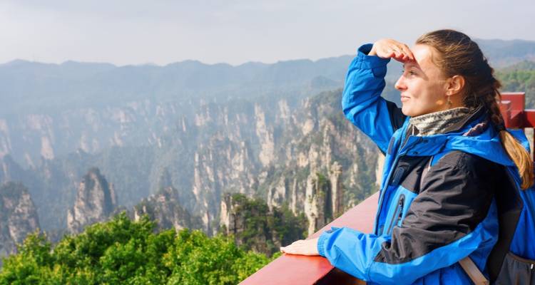 Woman looking out over the Zhangjiajie mountains.