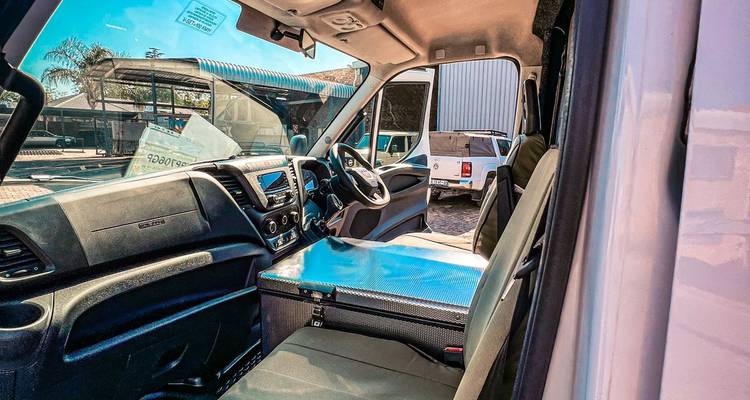 Driver’s cabin of the safari minibus featuring modern dashboard and seating.