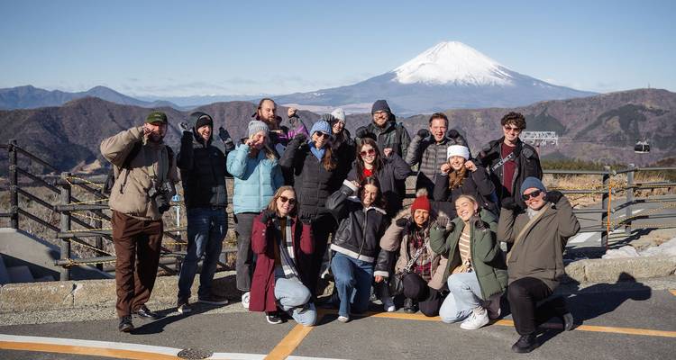 Group photo with a mountain backdrop.