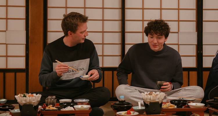 Two people having a traditional meal in a Japanese setting.