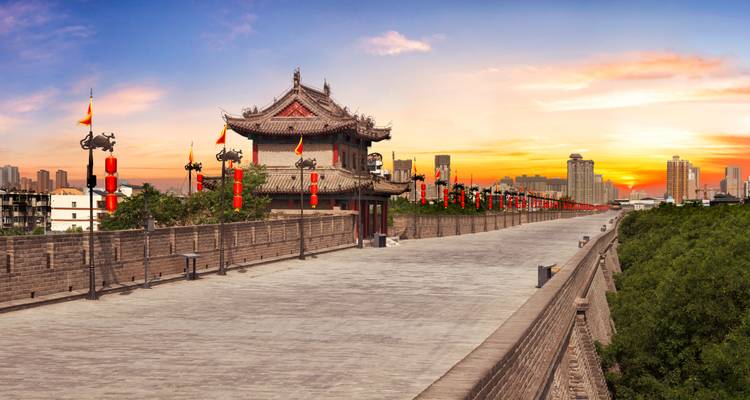 Xi'an City Wall with lanterns at sunset.