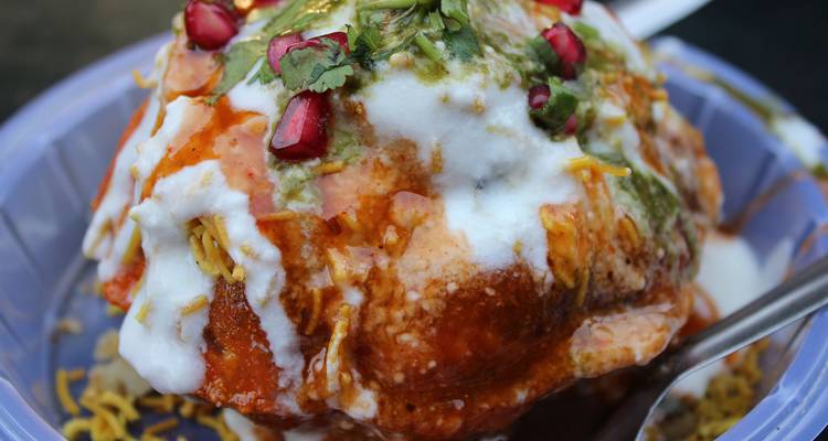 Traditional Indian dish garnished with pomegranate seeds and herbs.