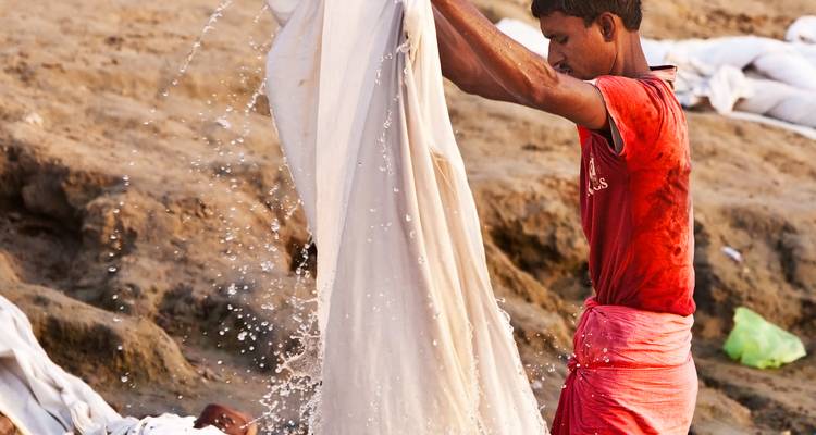 Person washing laundry in river