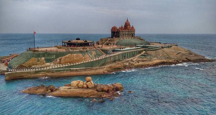 Vivekananda Rock Memorial on a rocky island surrounded by the ocean.