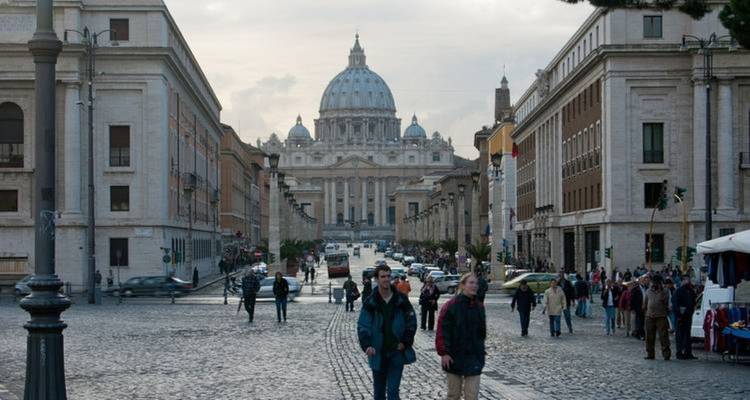 Busy street scene with St. Peter's Basilica in the background.