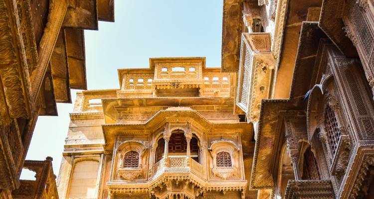 Intricately carved historic building with blue sky.