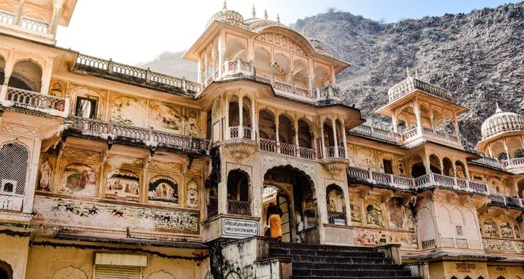 Palace with ornate architecture in a rocky setting.