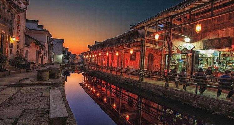 Vibrant street scene at sunset with traditional architecture.