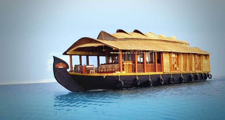 Traditional houseboat floating on clear water.