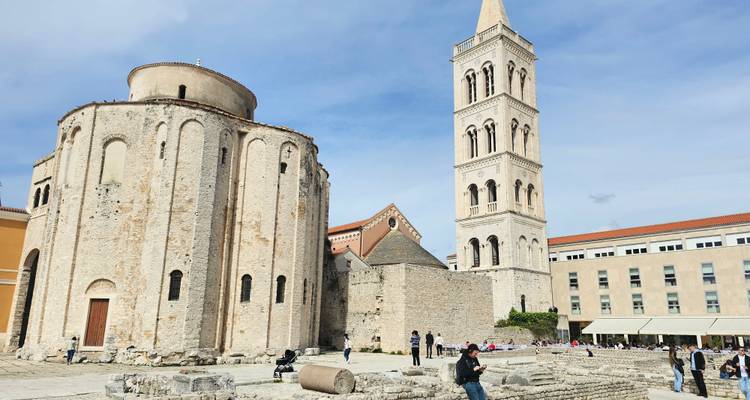 A historic church with tourists exploring.